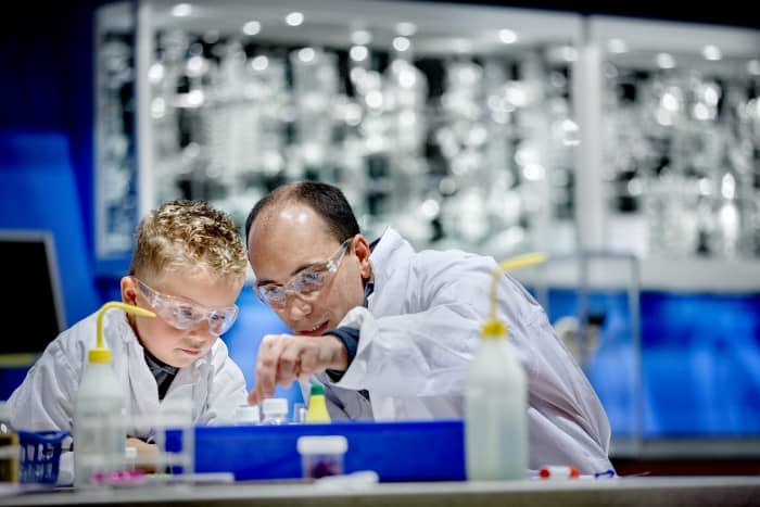 Scientist teaching a young student in a Netherlands lab