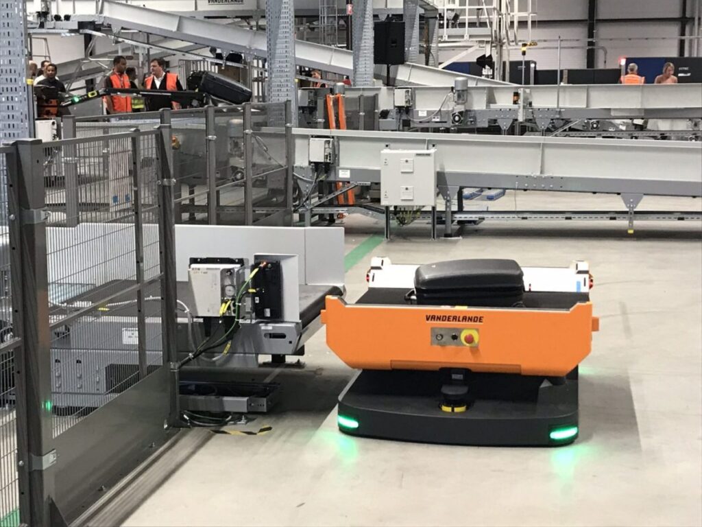 orange autonomous vehicle in a warehouse
