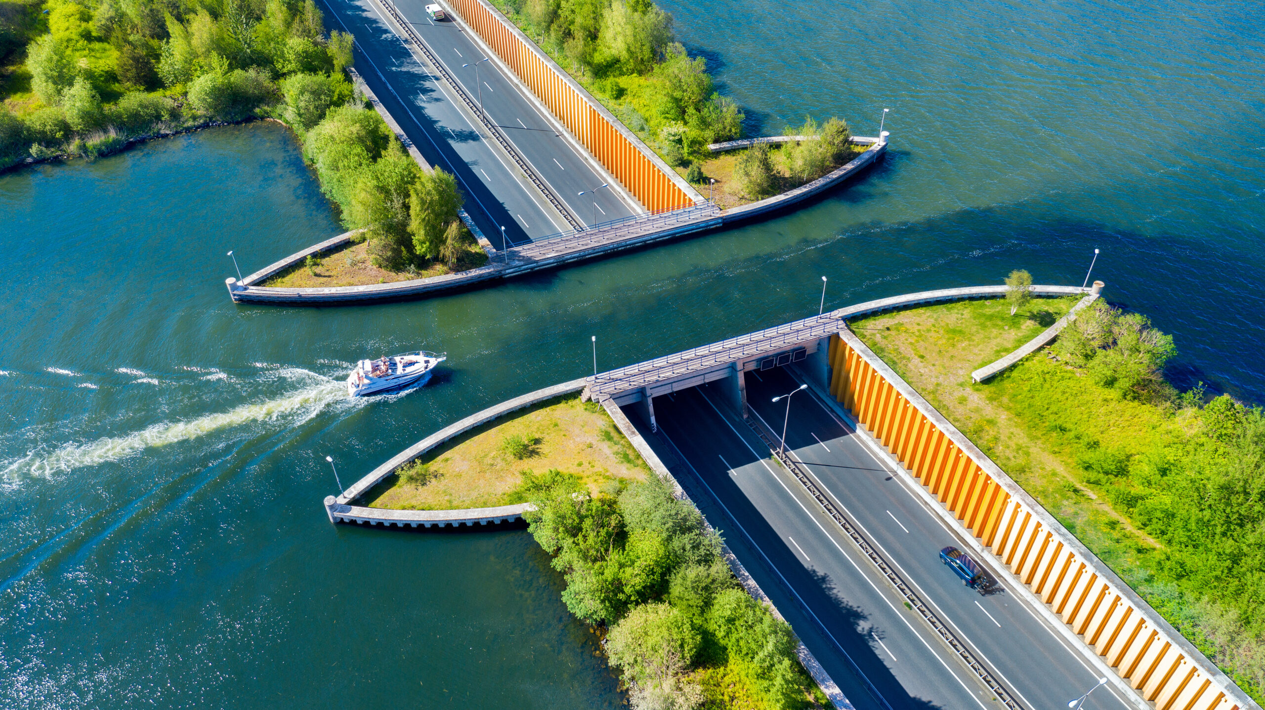 Aerial view of an open aquaduct. Roadways on either side with water flowing in between—Invest In Holland.