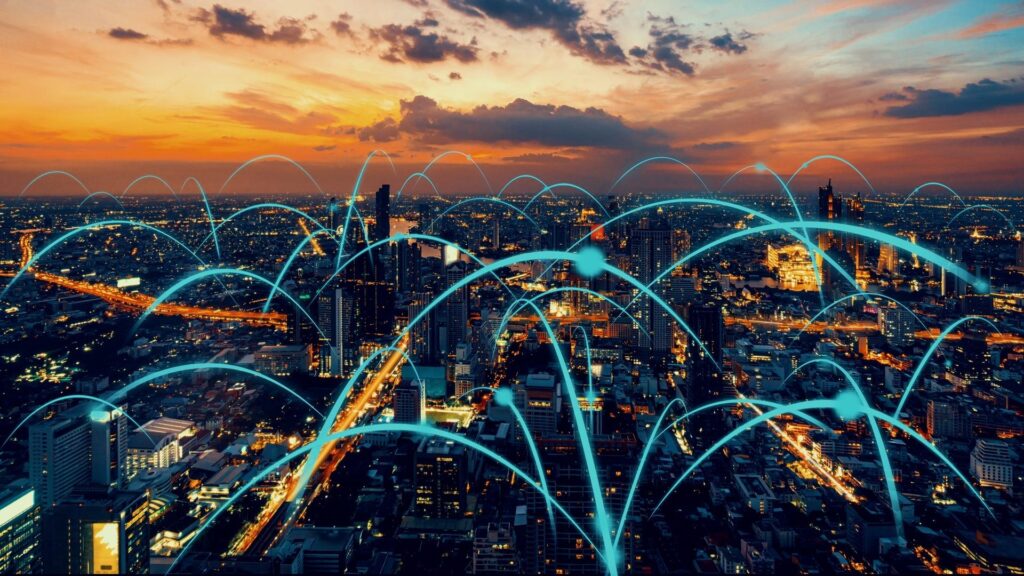 a stock image with a dark city covered by neon lines indicating smart grid 