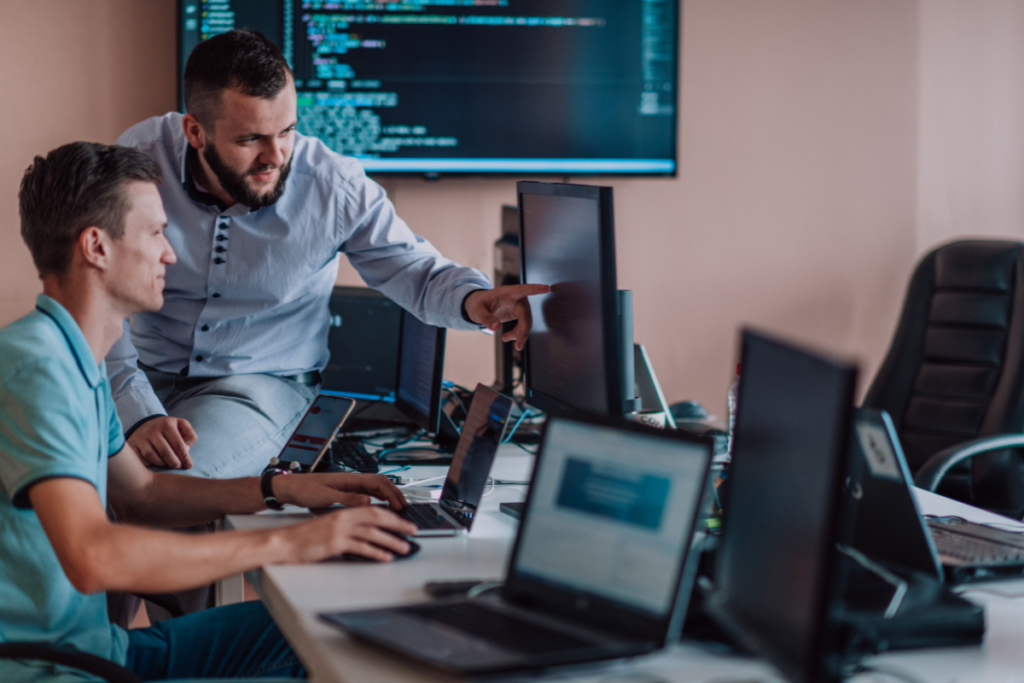 Two workers collaborating on computers in an office. Invest in Holland. 