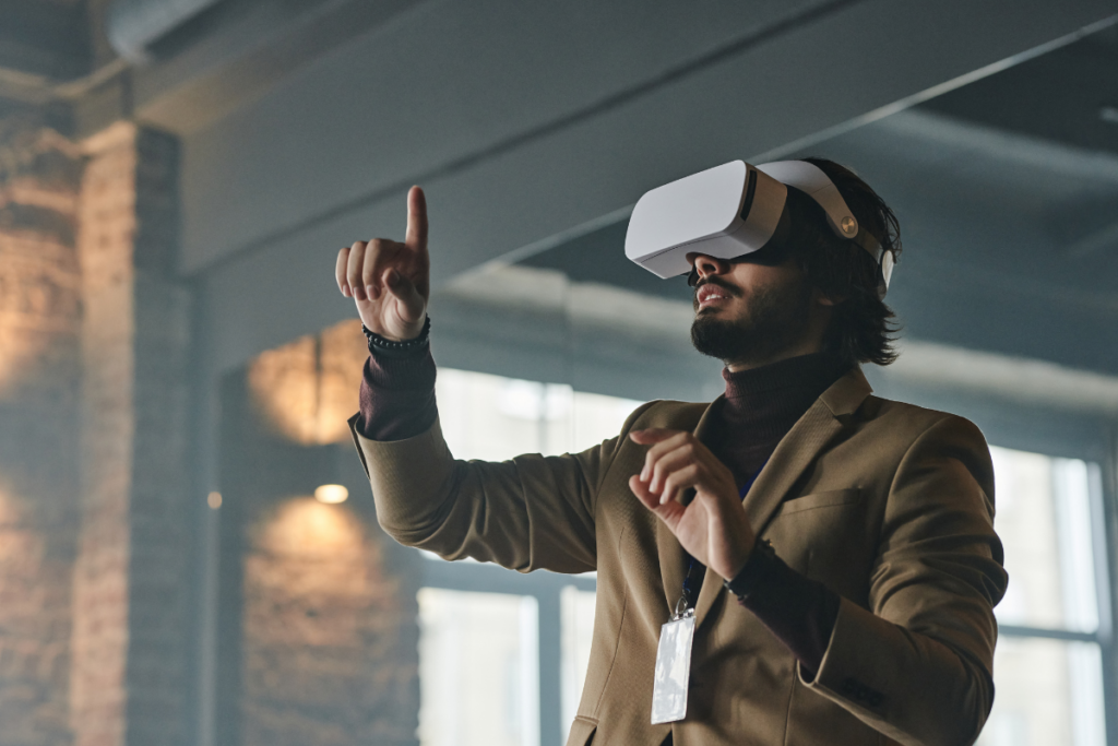 Man in corporate attire wears an augmented/virtual reality headset. Invest in Holland.