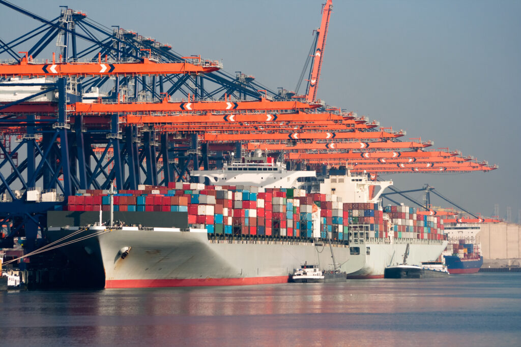 Cranes and container ships at the Port of Rotterdam. Invest in Holland.