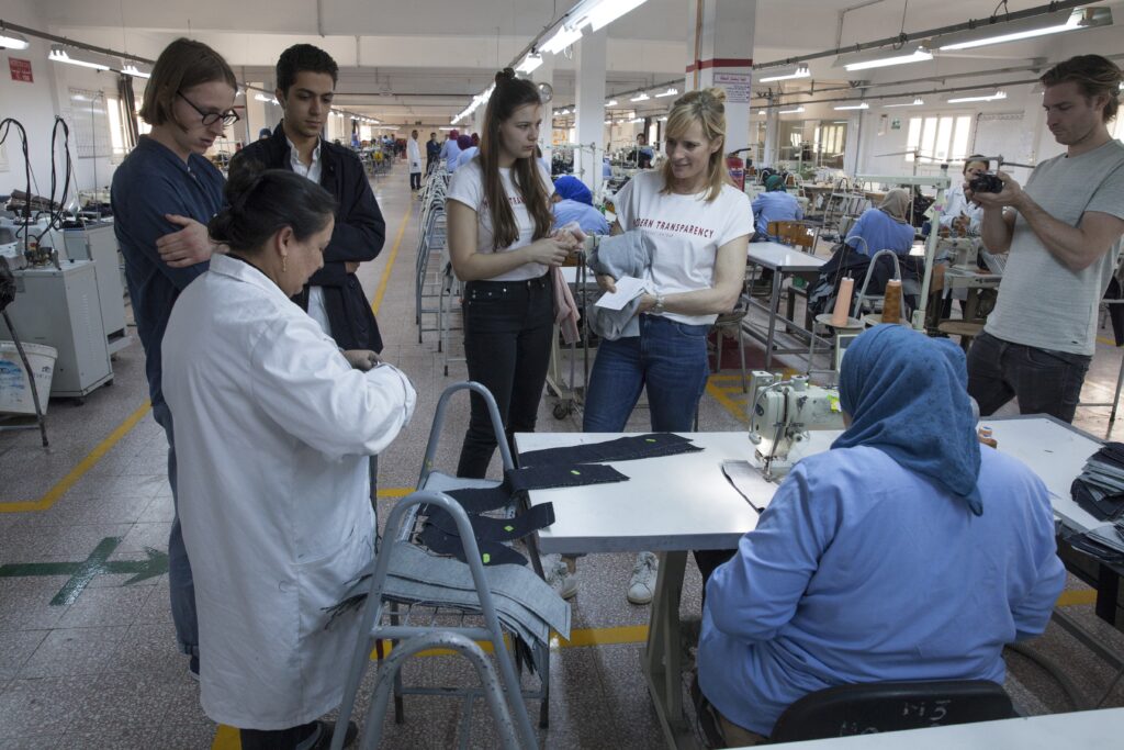 Multiple people in MUD Jeans factory in the Netherlands. Invest in Holland.